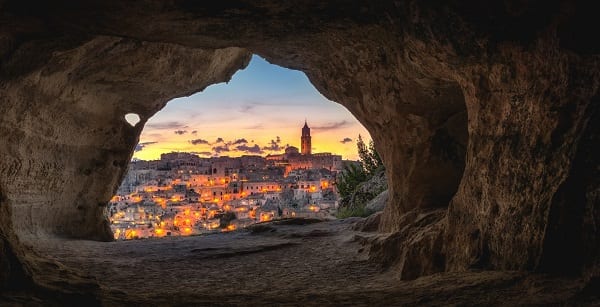 looking out from a cave into a gorgeous city