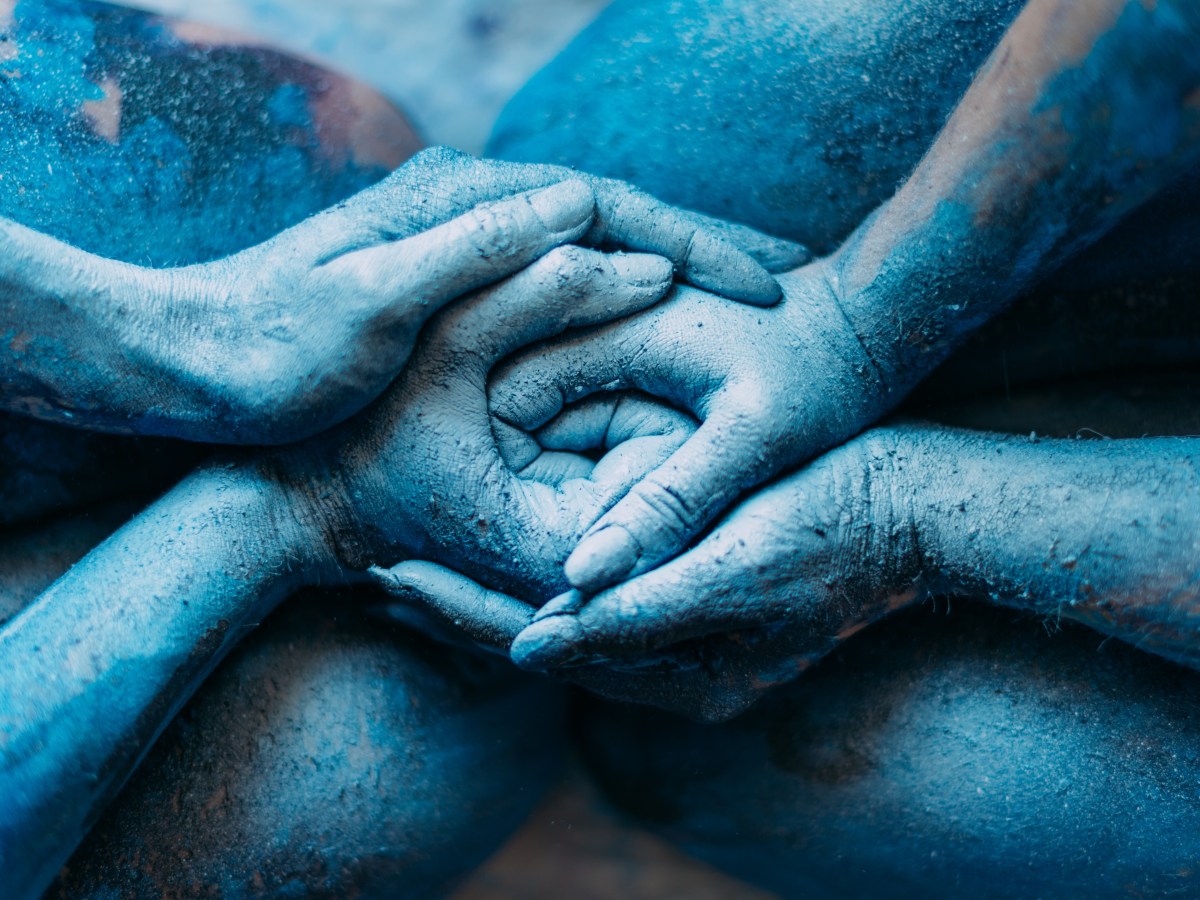 Winter | multiple human hands nestled together, blue in color