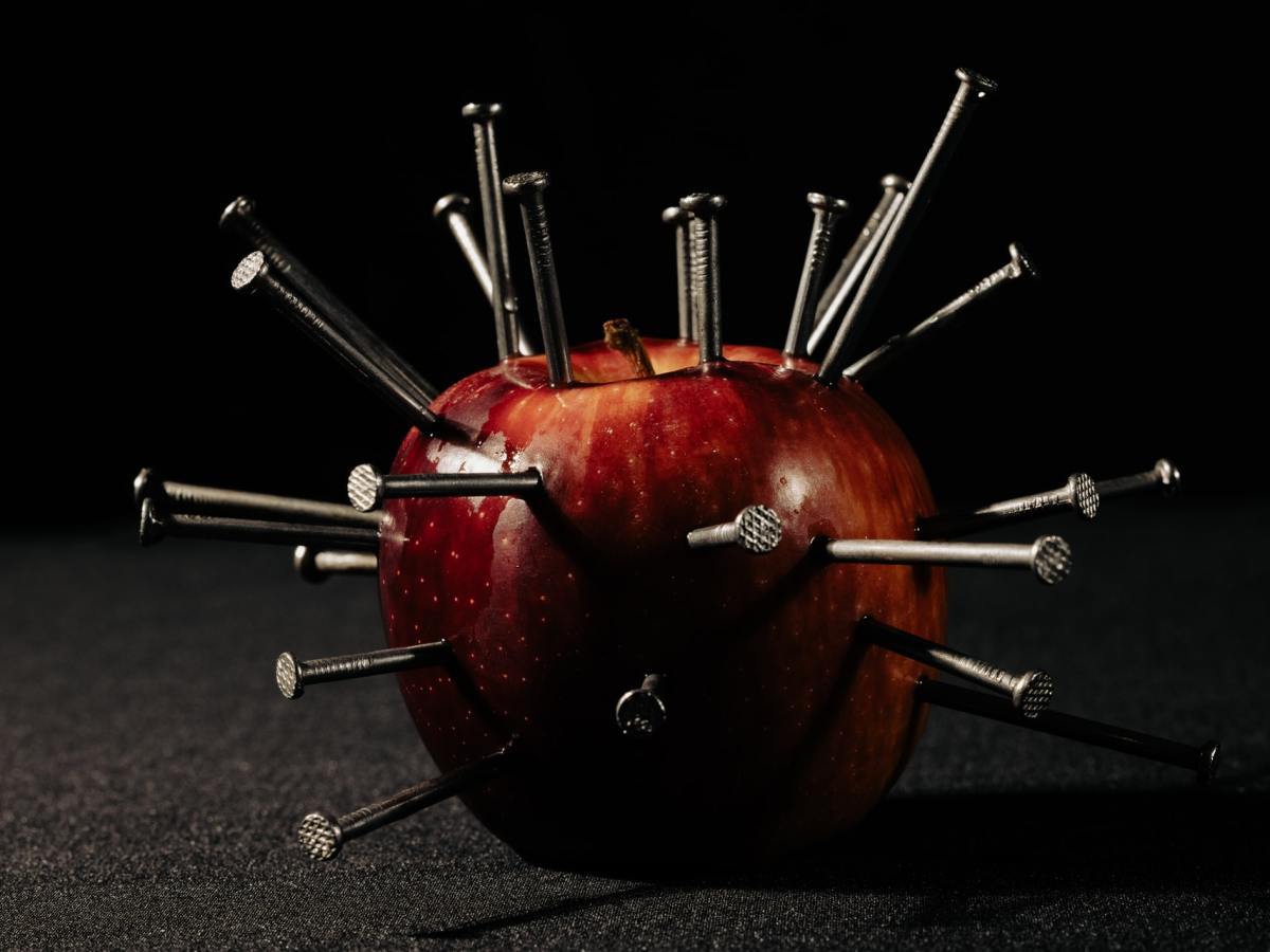 Eve | An apple with nails sticking out of it, sinister and dark background