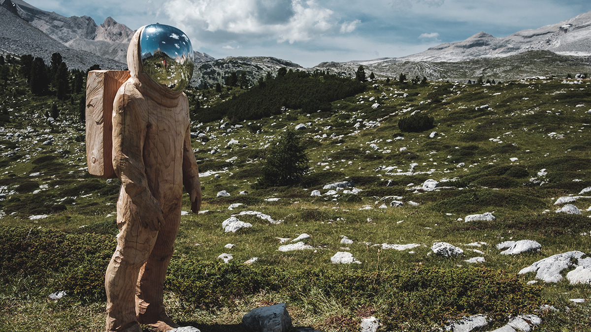 Stuff they don’t tell you about grieving: The “Space Cadet” stage | Wooden astronaut statue in mountain meadow