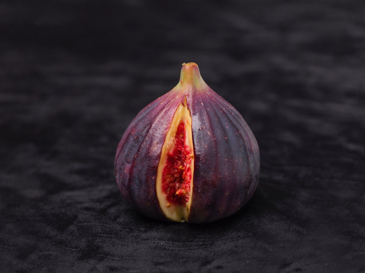 Getting to know and love your vaginal fluids | a fig with a slice cut out, which looks suggestively like genital folds