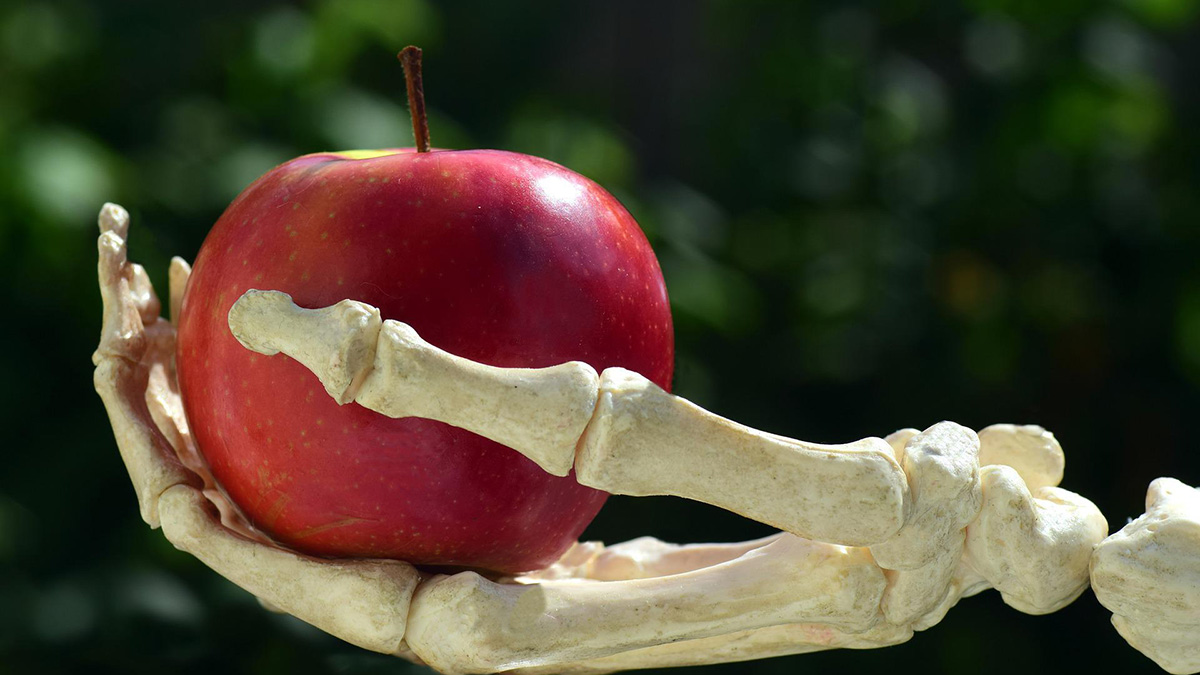 Religious toxicity and grief: When to ignore, when to retaliate | Skeletal hand, holding out an apple