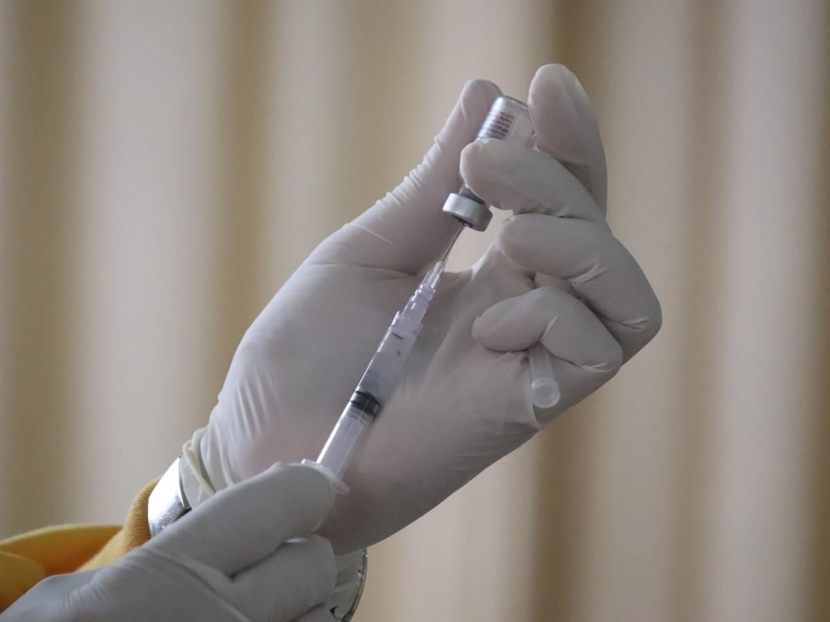 A tale of two vaccines: How tribalism fuels science denial. Vaccine vial and needle
