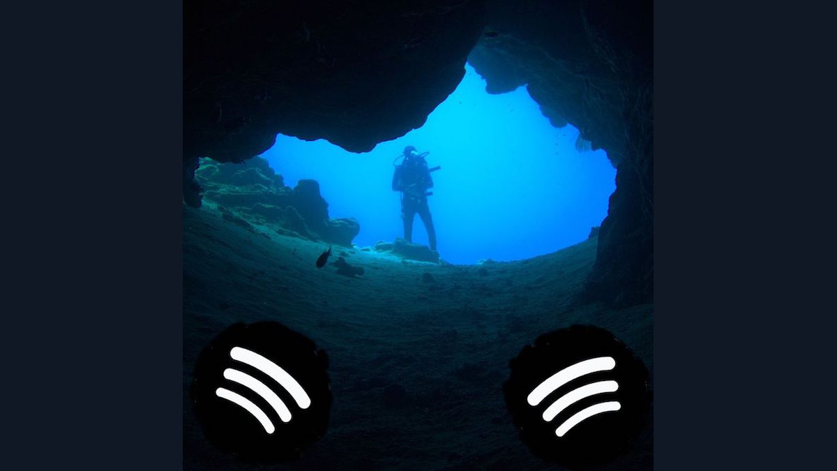 scuba diver looking into cave