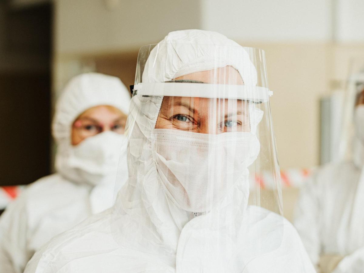 Is the pandemic over Depends who you listen to | woman in PPE
