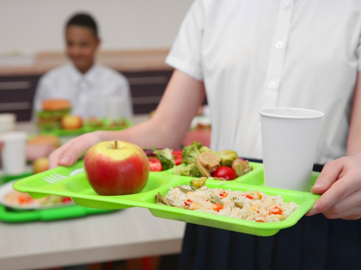 St. Louis Archdiocese chooses anti-LGBTQ bigotry over free school lunch | A student carries a lunch tray at school